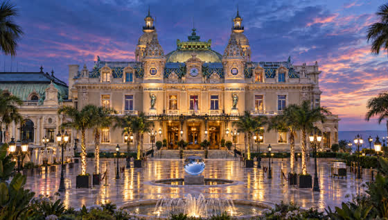 The Casino de Monte-Carlo and its square at dusk, empty and lit